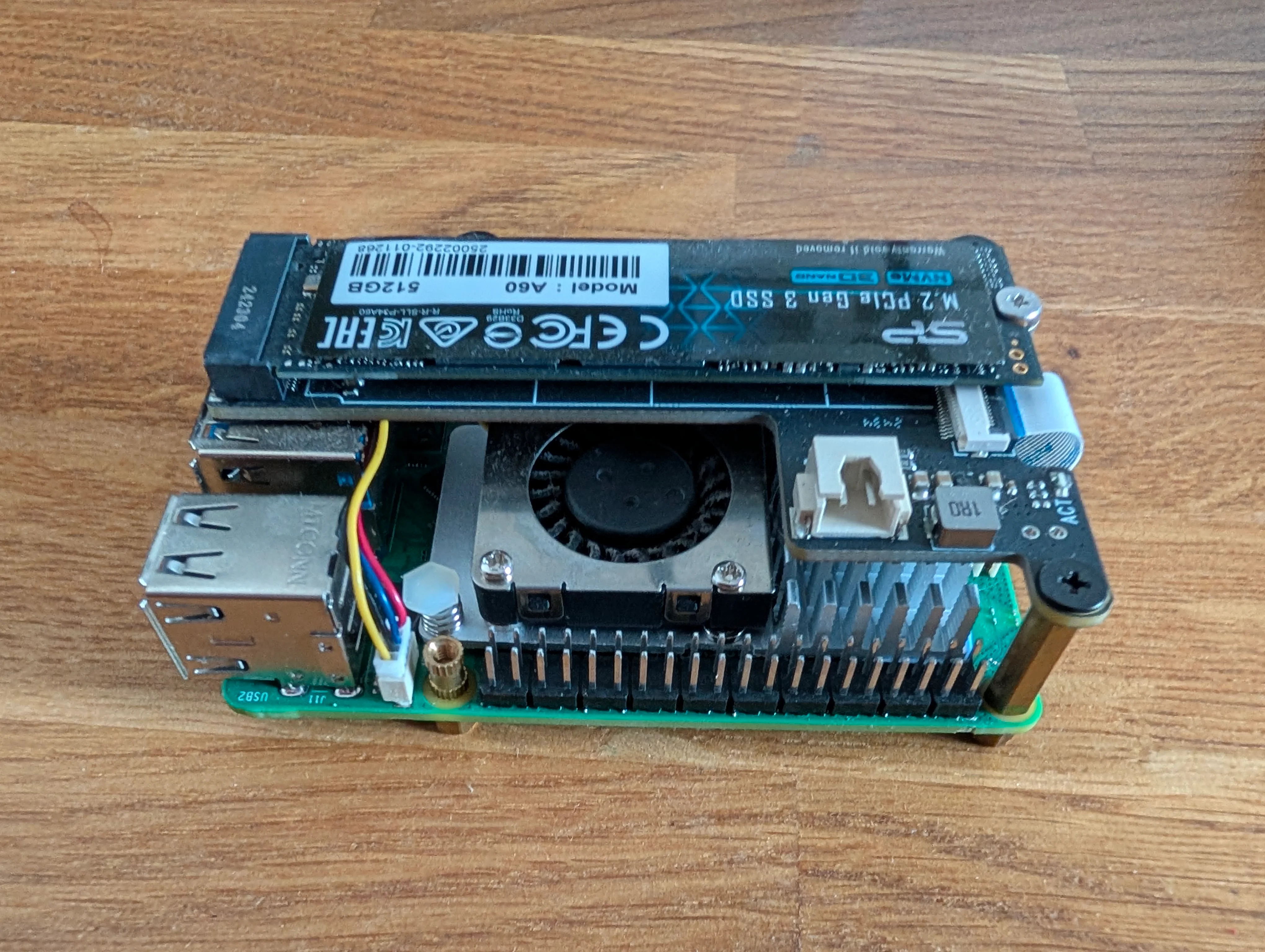 A Raspberry Pi 5 with a PCIe SSD shield, an NVMe SSD, fan, and radiators